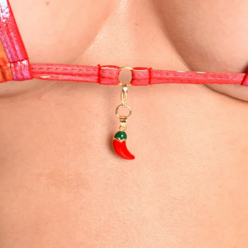 Close-up of the gold and enamel chili pendant on the Chili Charm Classic Triangle-Top underbust band.